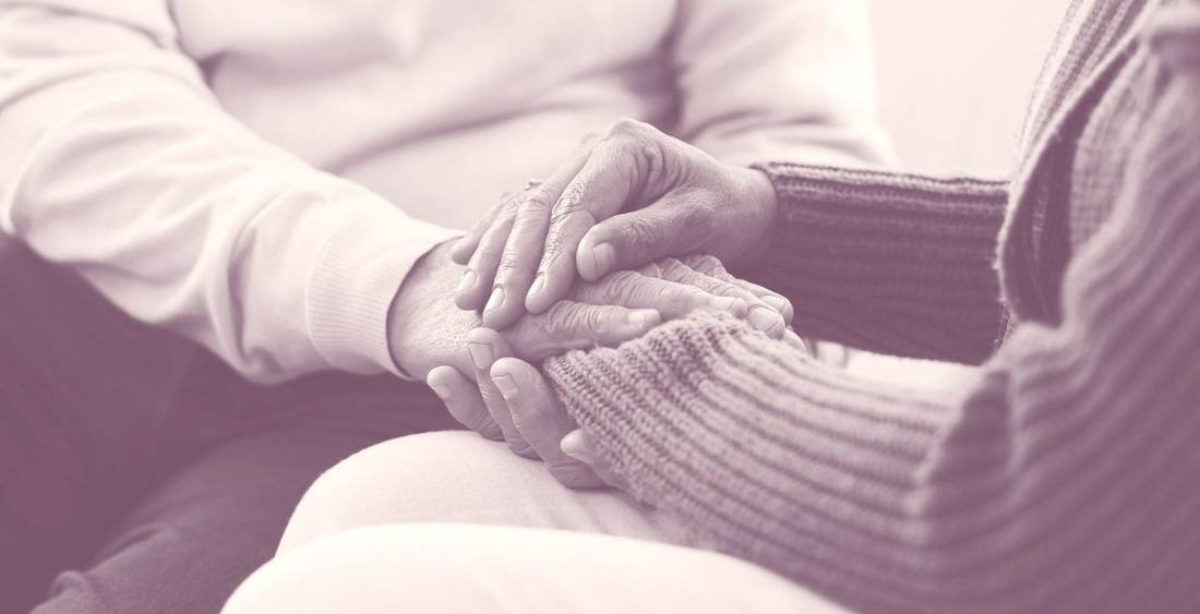 Clasped hands in caring gesture